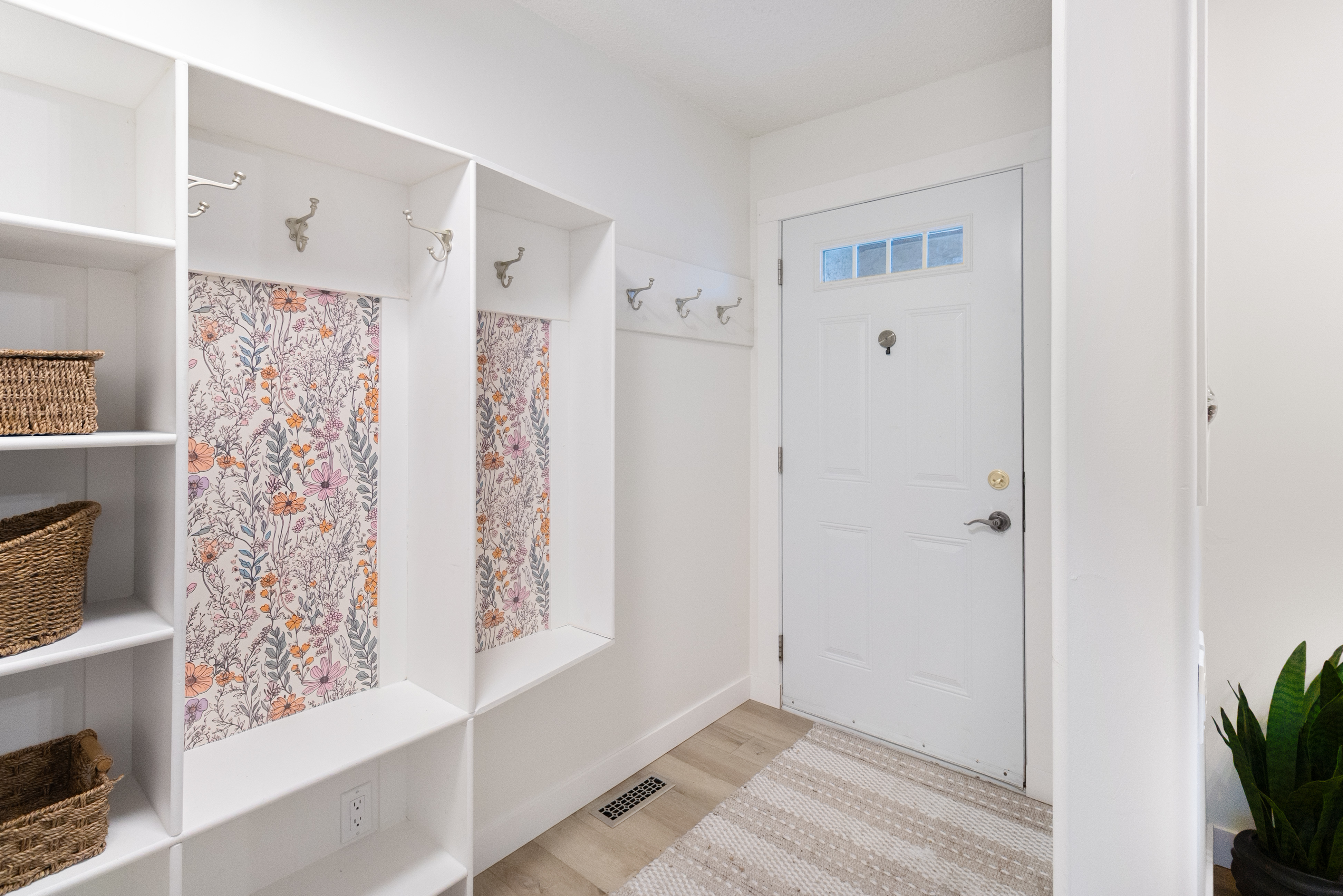 Fort Sask mudroom — floral wallpaper accents, custom built-ins