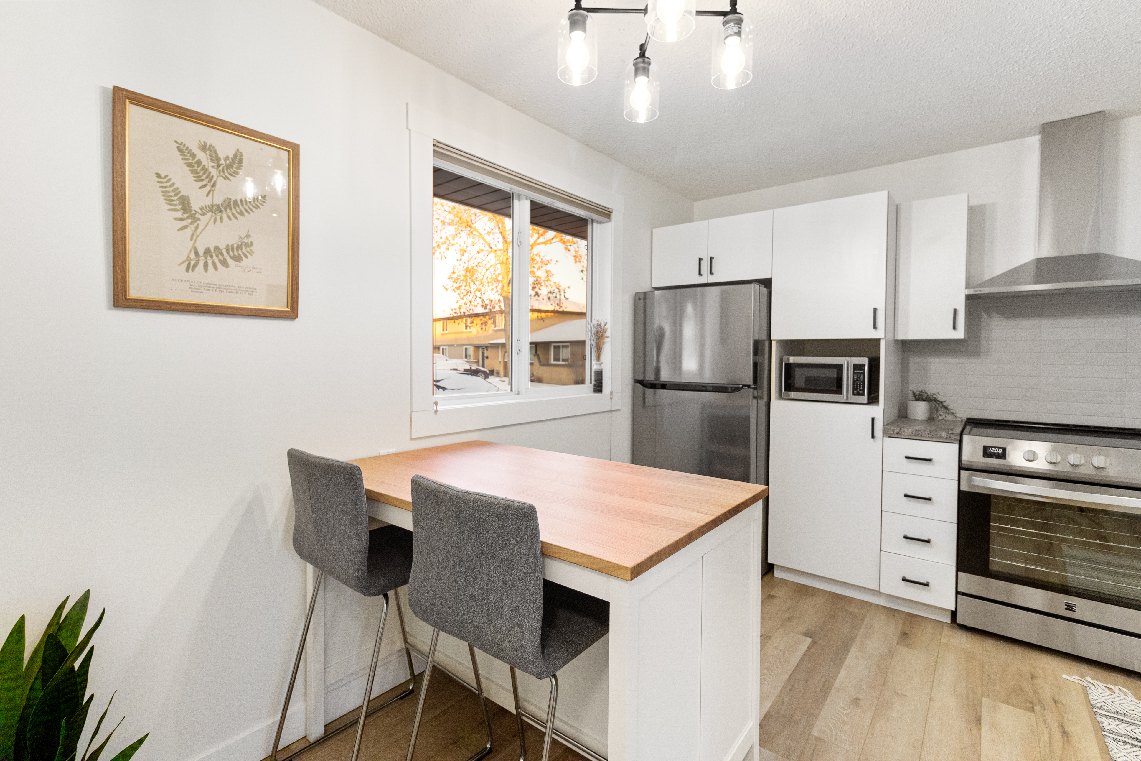 Fort Sask kitchen — butcher block island, stainless appliances