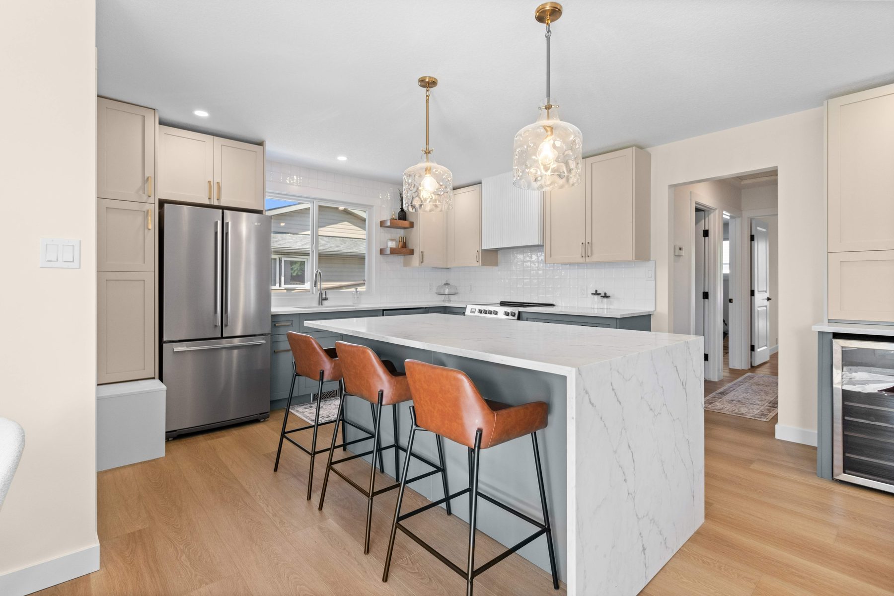 Garland kitchen — marble waterfall island and wine fridge